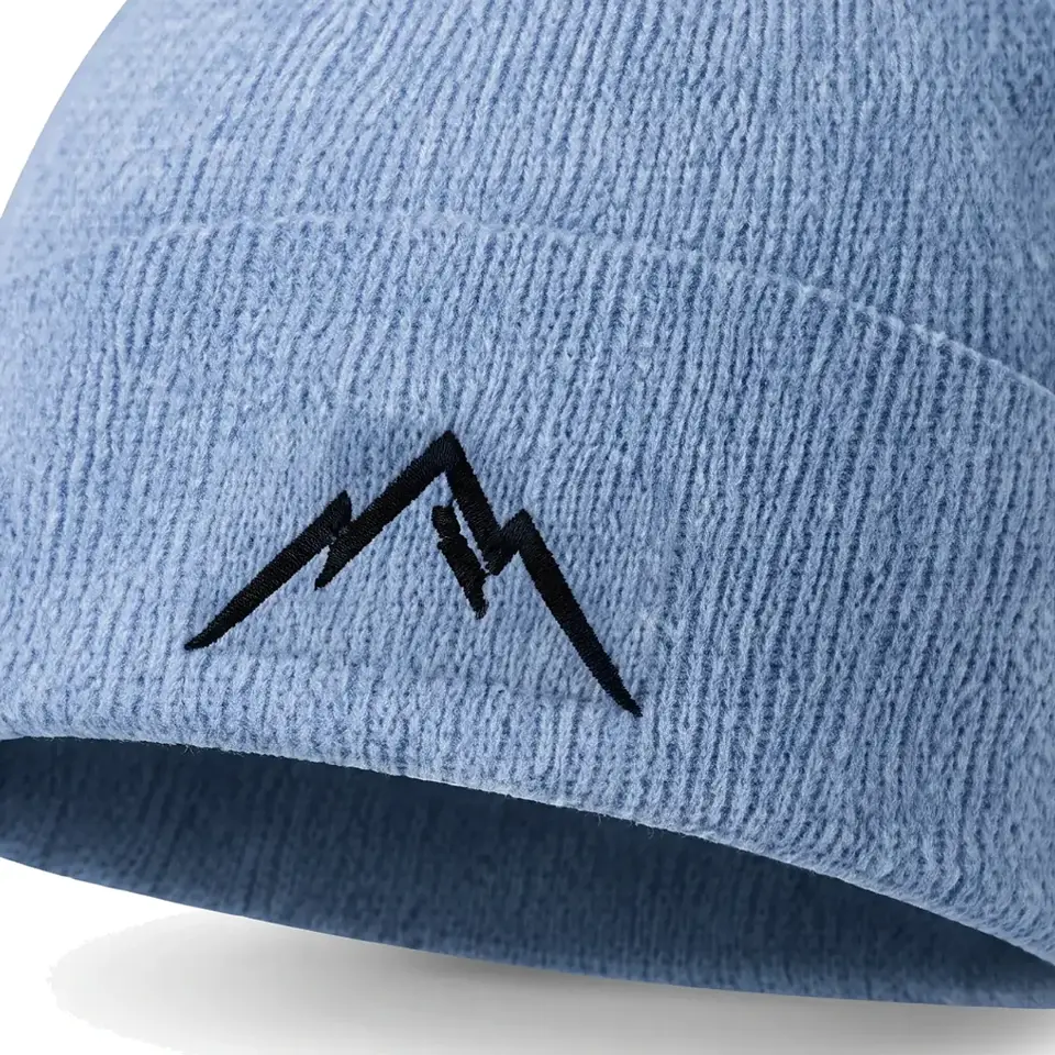 Col Rib beanie in Sky Blue: close-up of the cuff embroidery