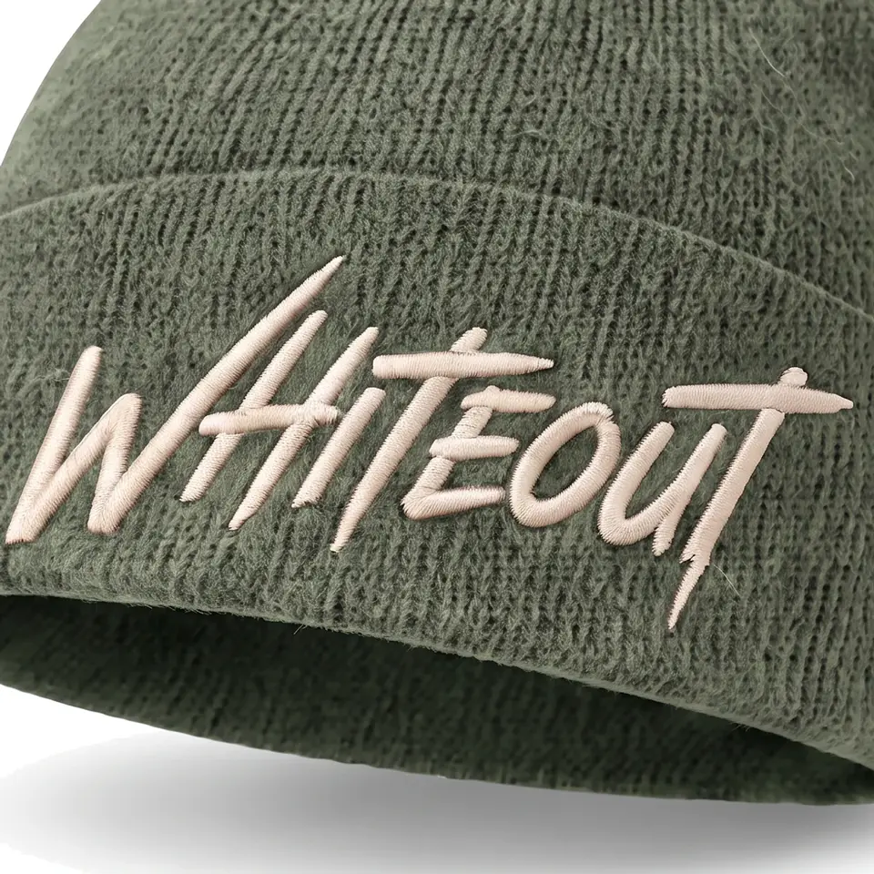 Chalet beanie in Sage: close-up of the cuff embroidery