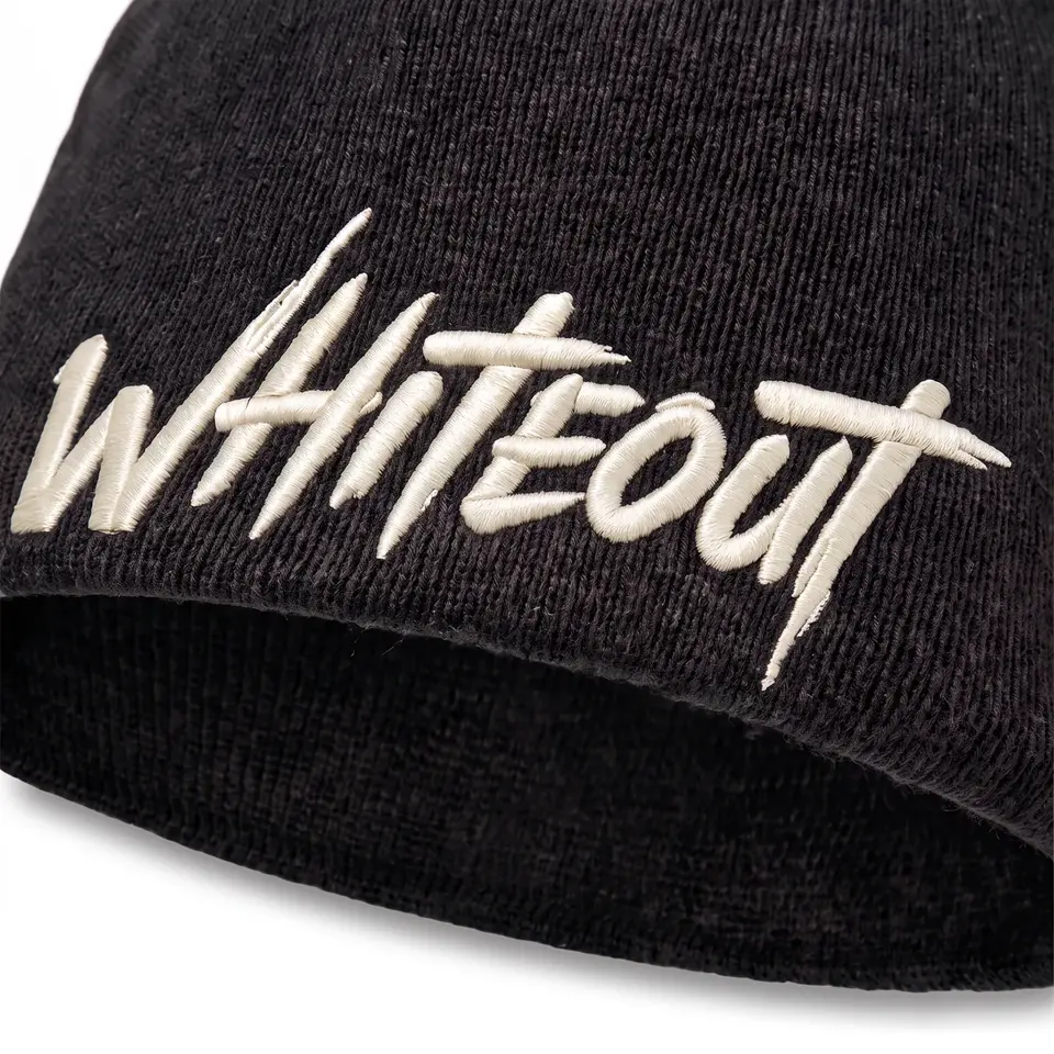 Ascent Skull Cap beanie in Black: close-up of the cuff embroidery