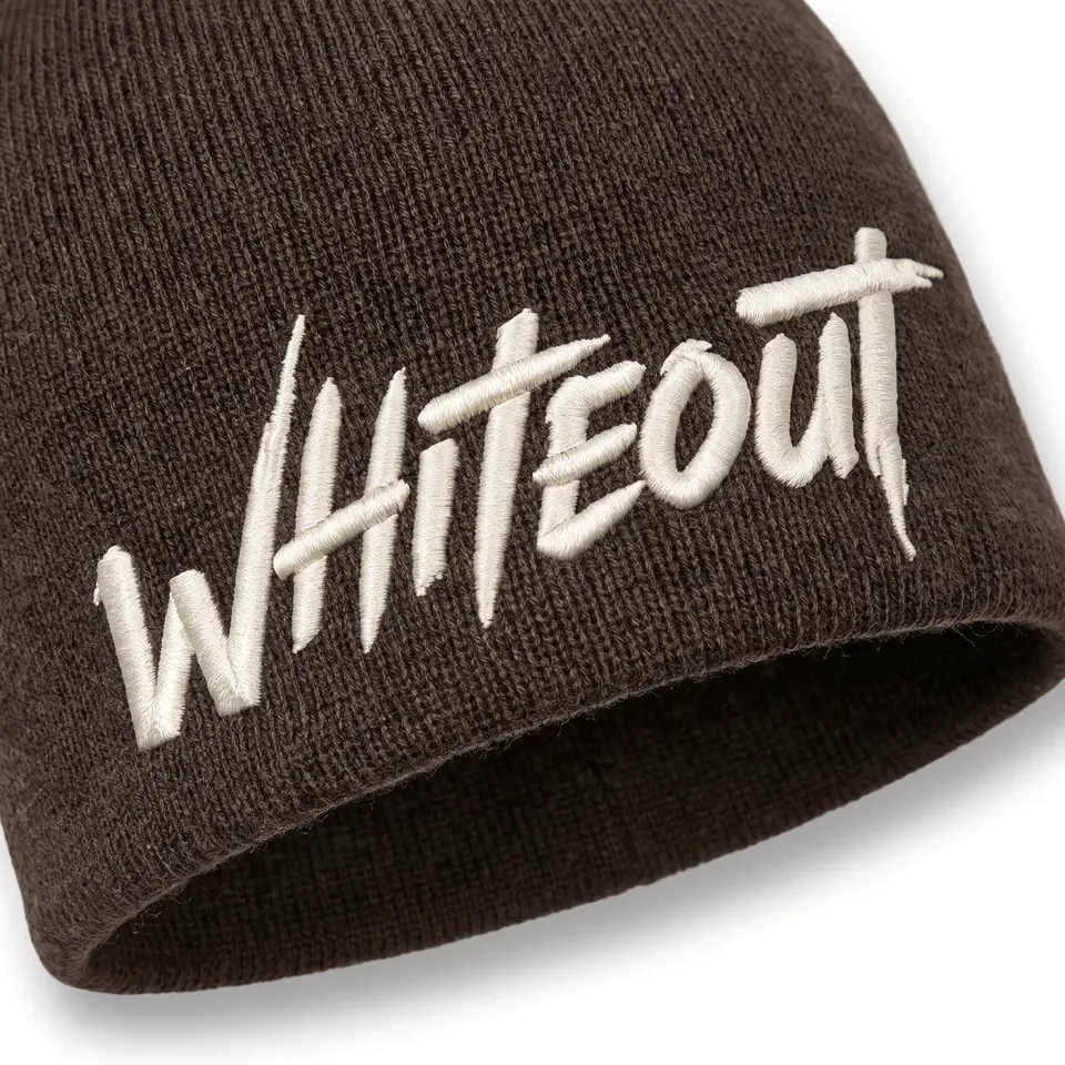 Ascent Skull Cap beanie in Brown: close-up of the cuff embroidery