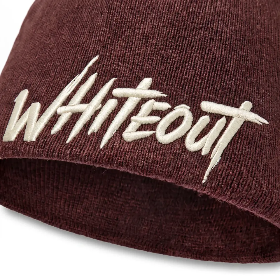 Ascent Skull Cap beanie in Burgundy: close-up of the cuff embroidery