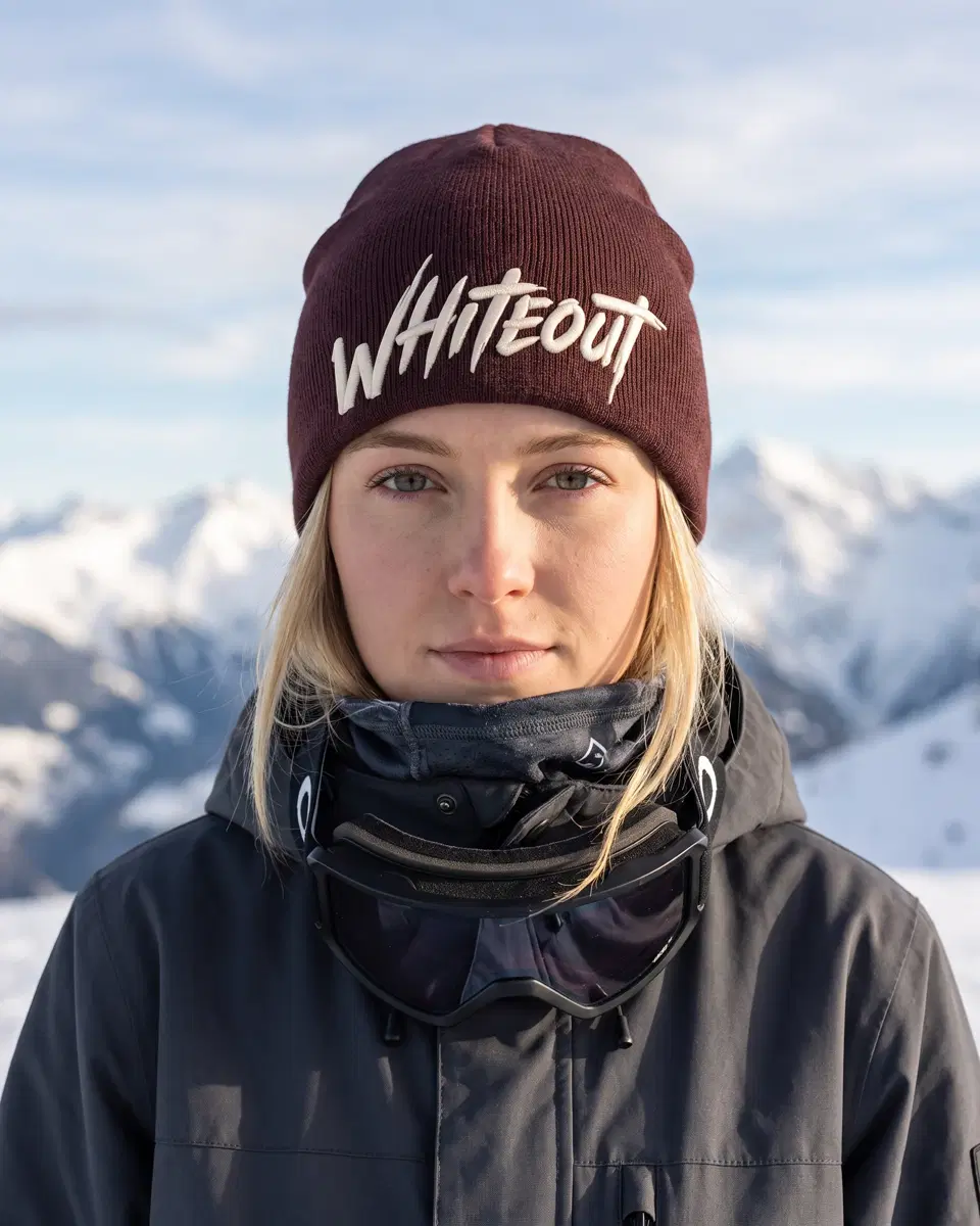 Snowboarder wearing the Ascent Skull Cap beanie in Burgundy