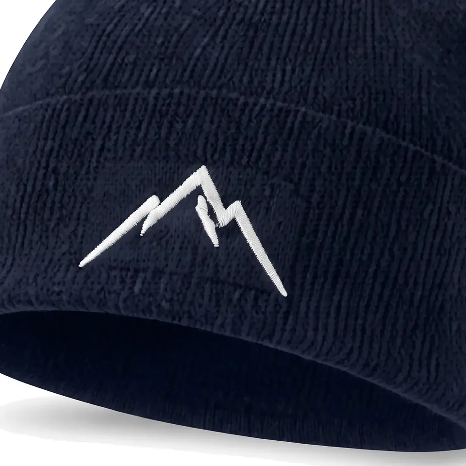 Col Rib beanie in Navy: close-up of the cuff embroidery
