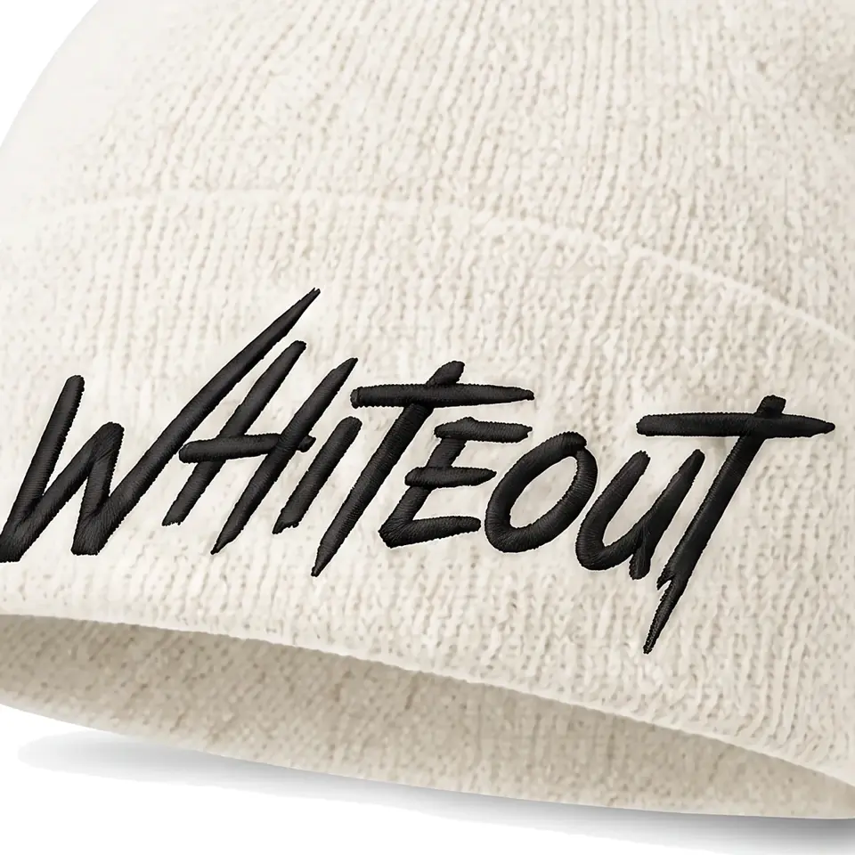 Chalet beanie in White: close-up of the cuff embroidery