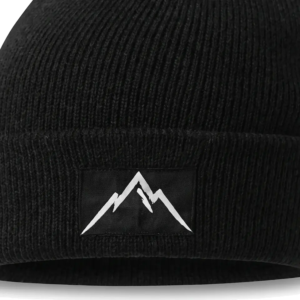 Crest beanie in Black: close-up of the cuff patch