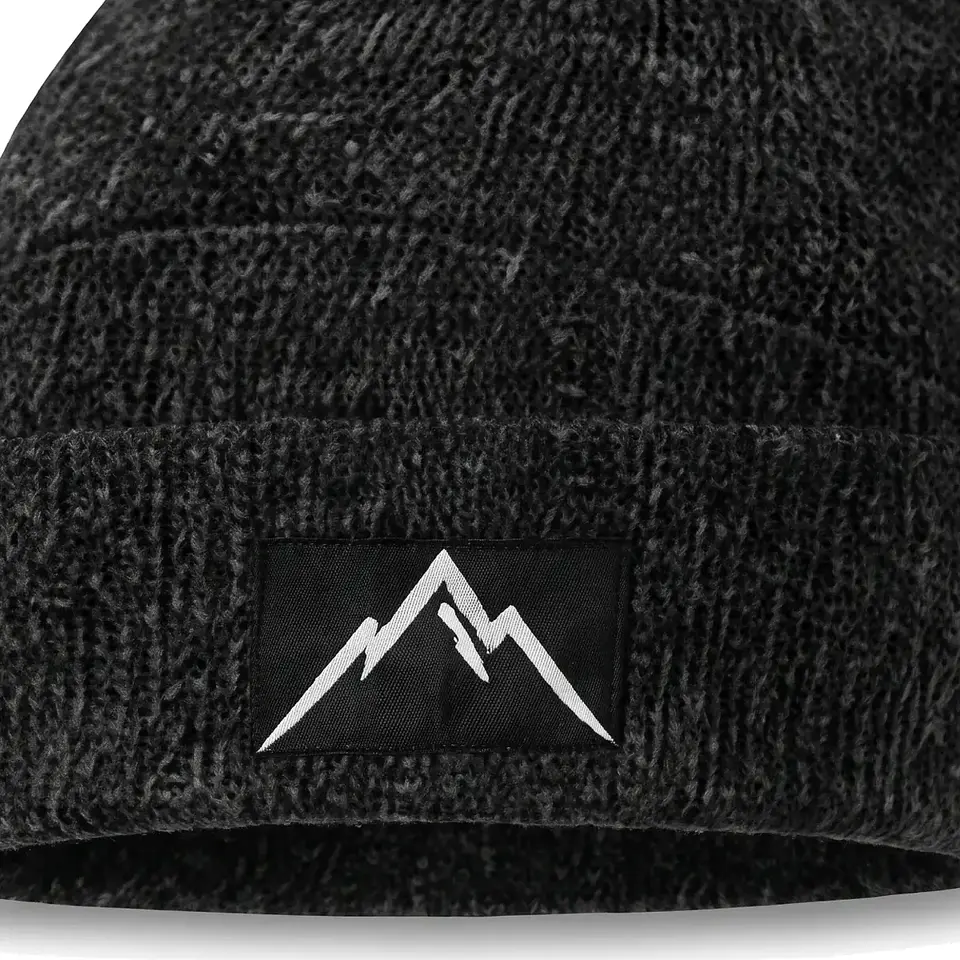 Crest beanie in Charcoal: close-up of the cuff patch