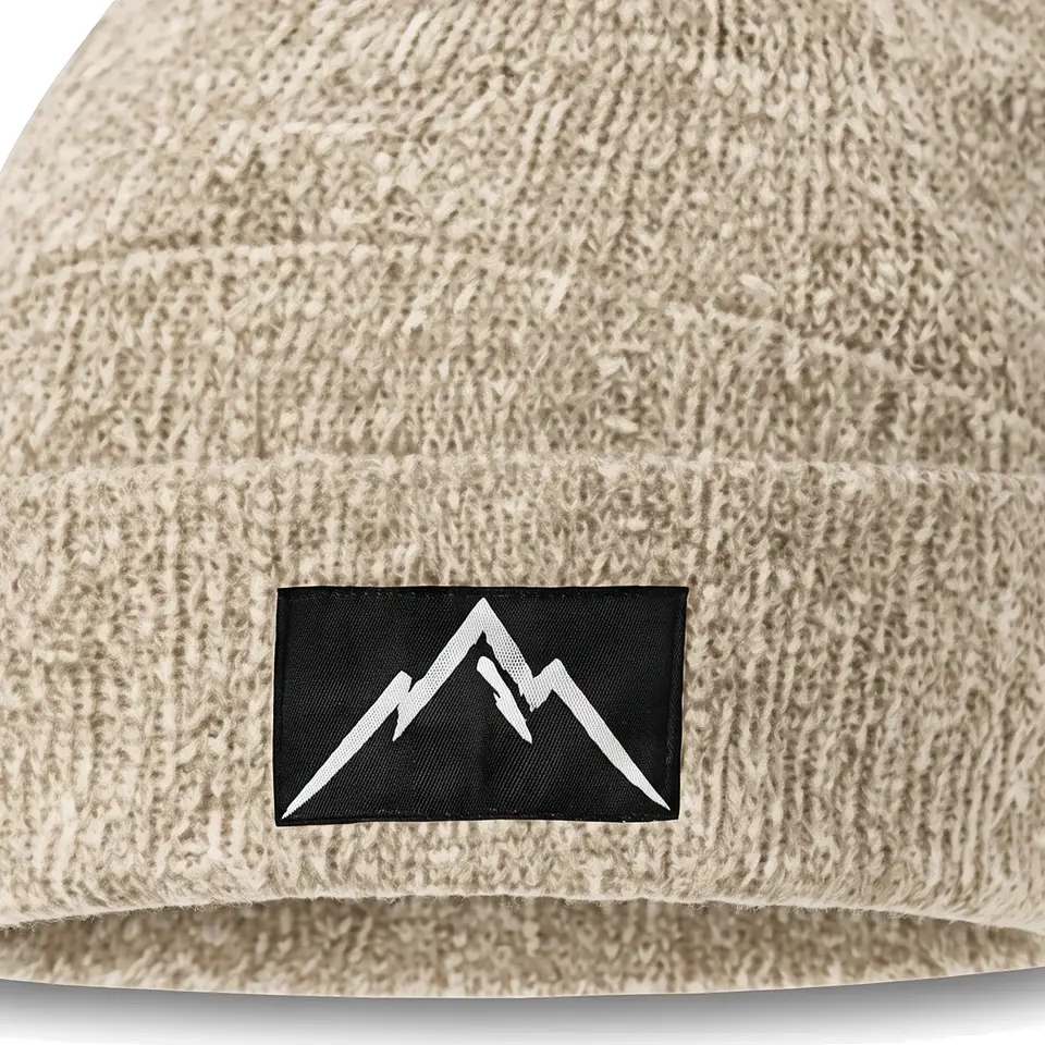 Crest beanie in Cream: close-up of the cuff patch