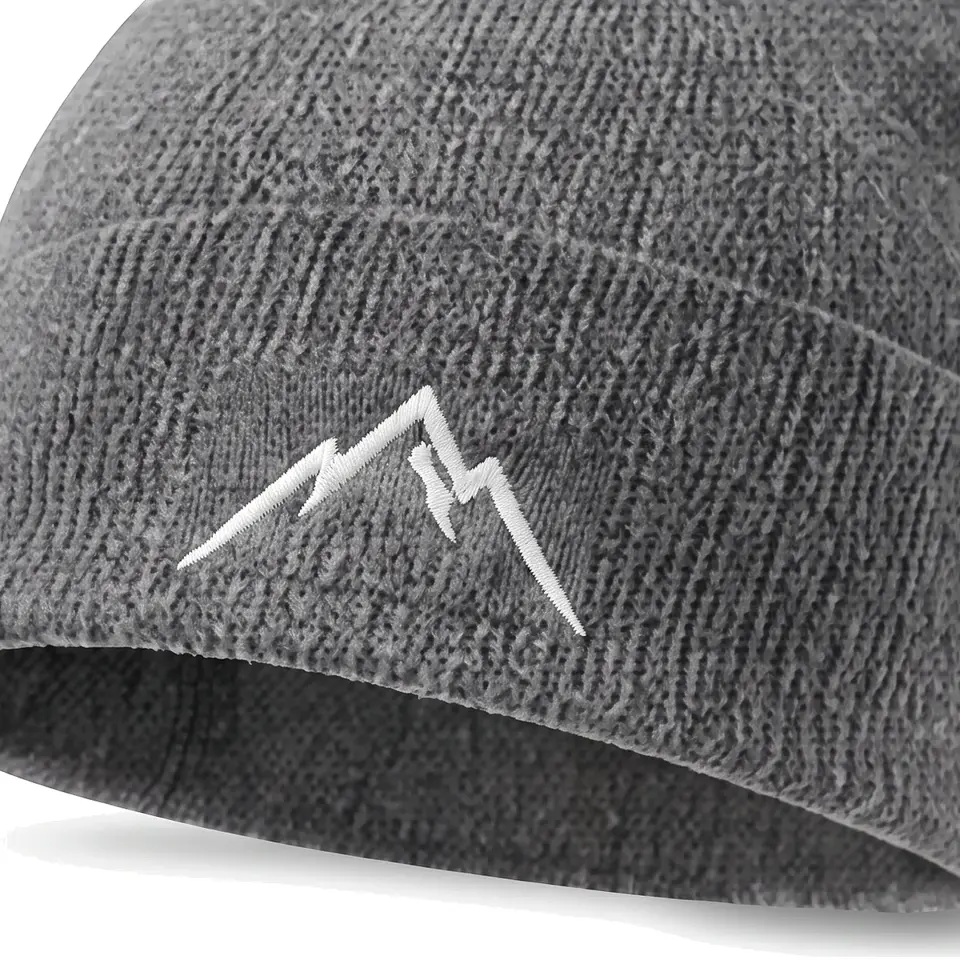 Col Rib beanie in Grey: close-up of the cuff embroidery