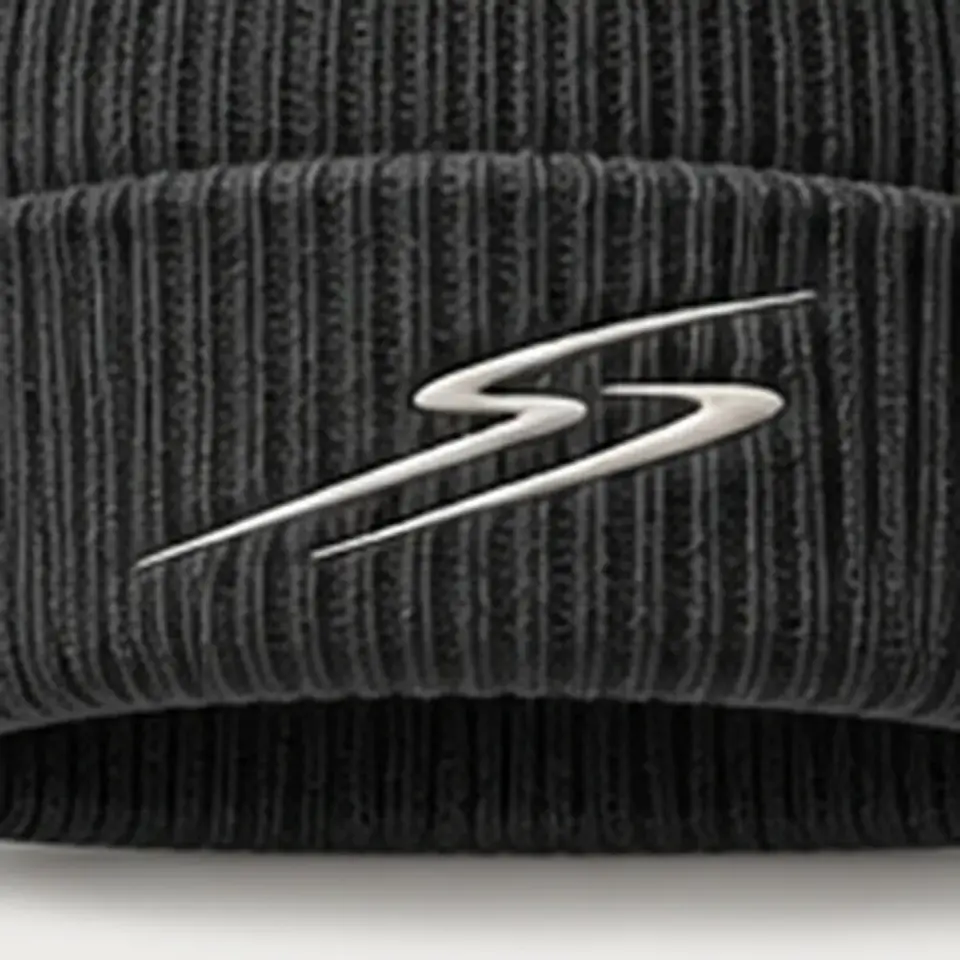 Drift beanie in Charcoal: close-up of the cuff embroidery