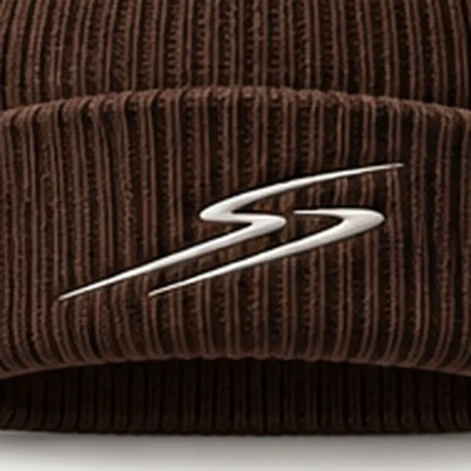 Drift beanie in Chocolate: close-up of the cuff embroidery