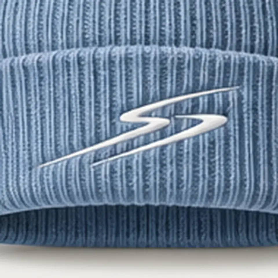 Drift beanie in Ice Blue: close-up of the cuff embroidery