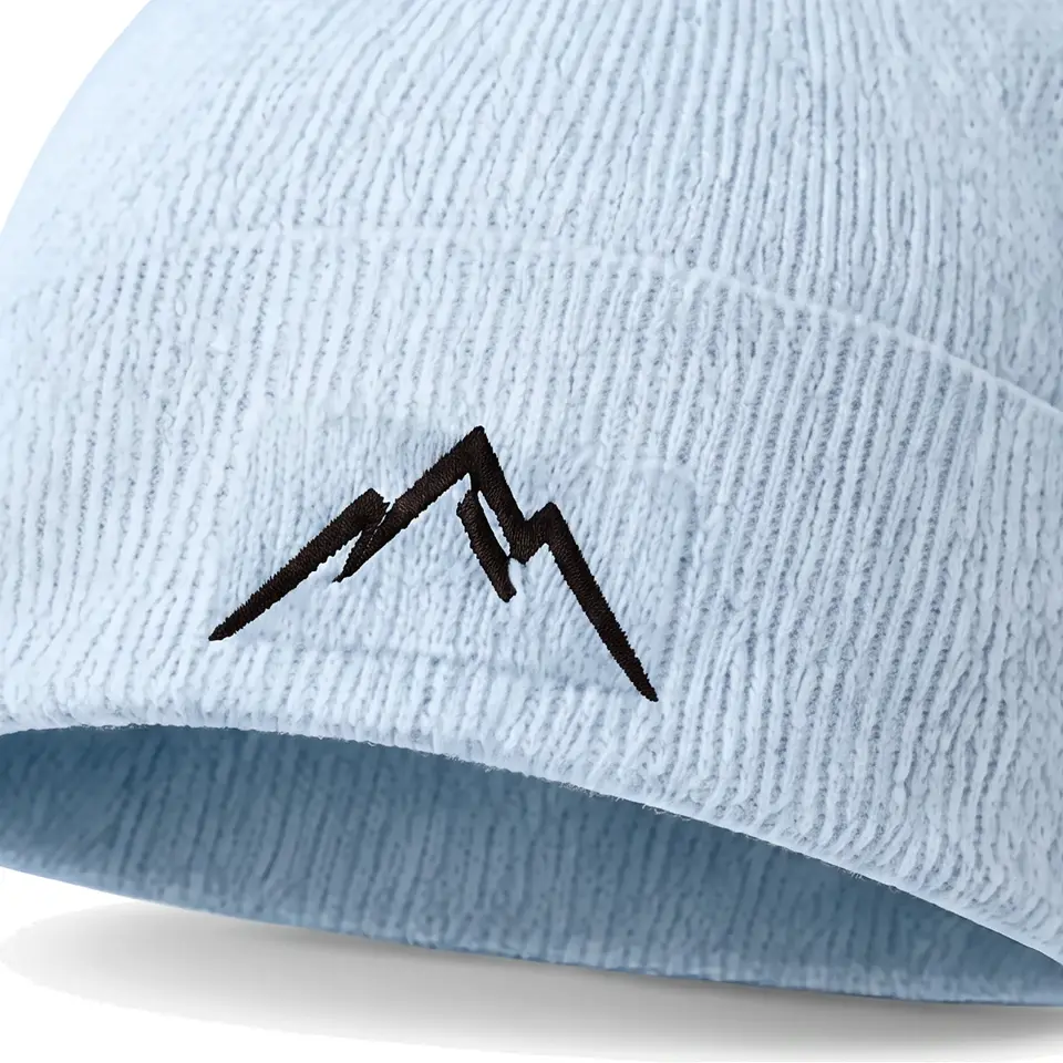 Col Rib beanie in Ice Blue: close-up of the cuff embroidery