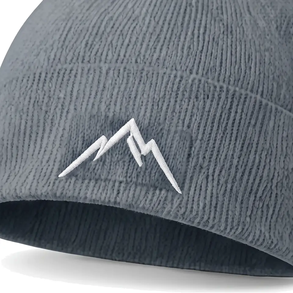 Col Rib beanie in Slate: close-up of the cuff embroidery