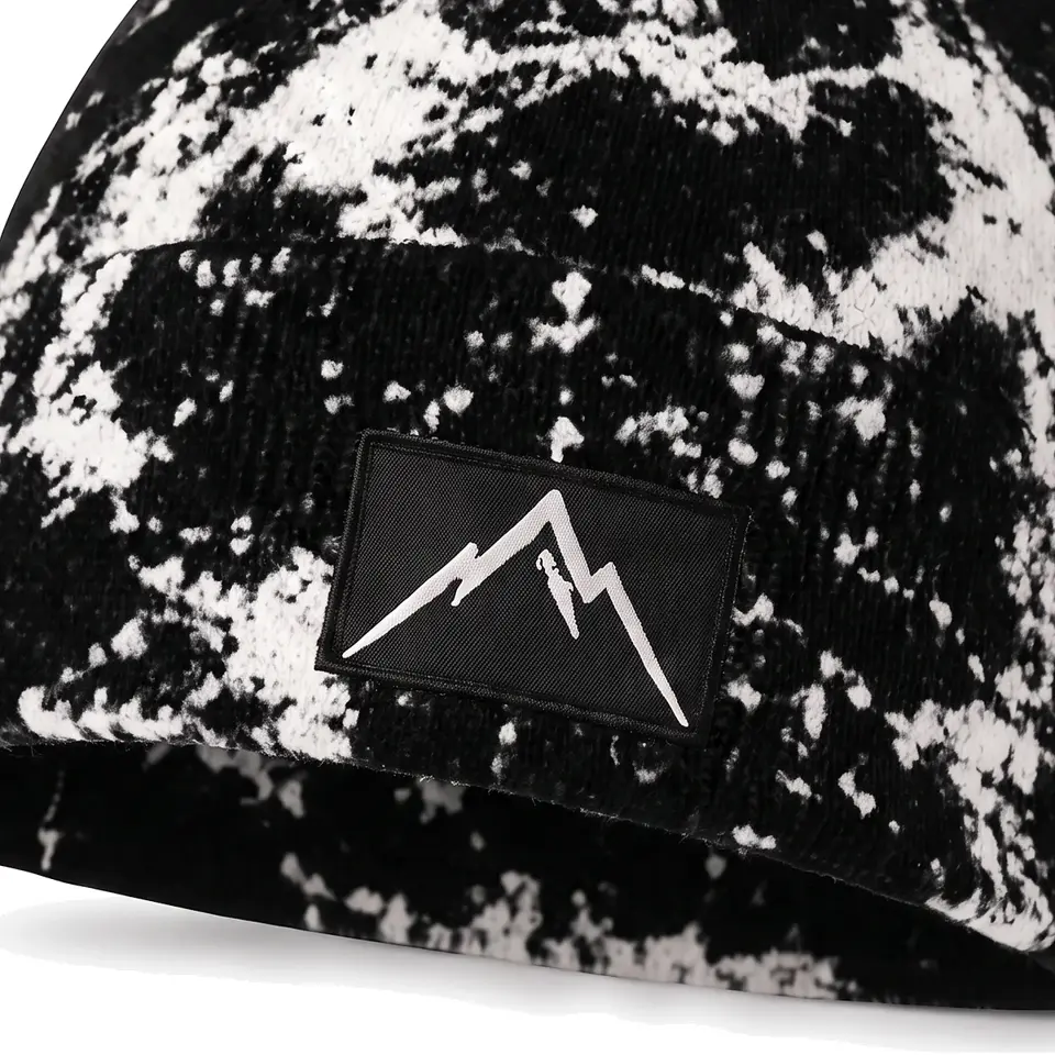 Haute Route beanie in Black: close-up of the cuff patch