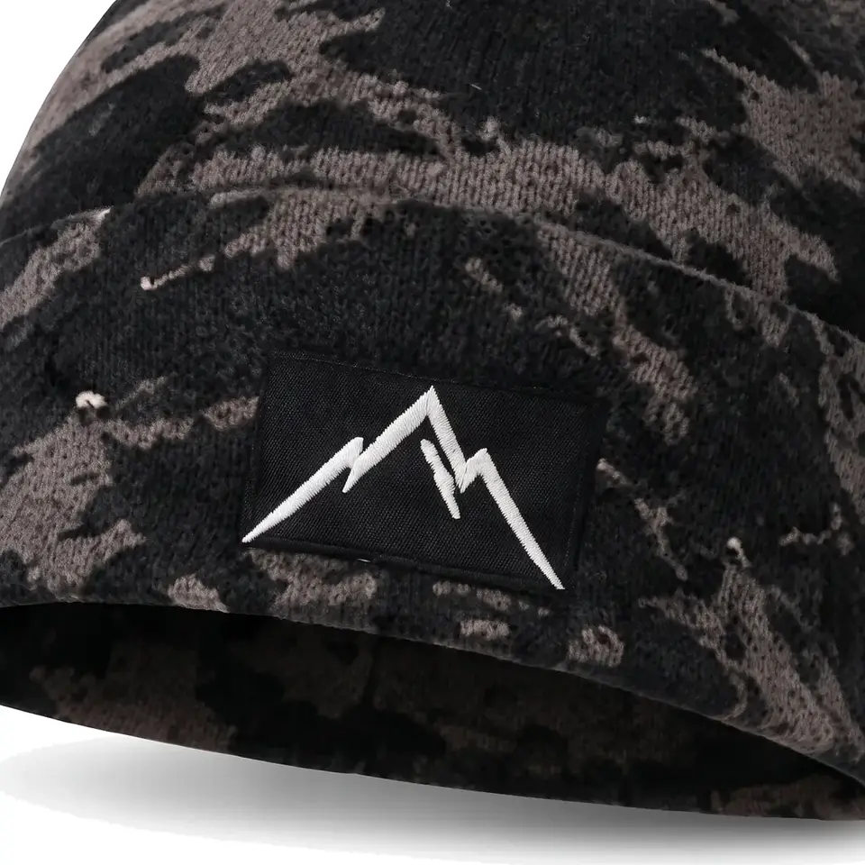 Refuge beanie in Grey Camo: close-up of the cuff embroidery