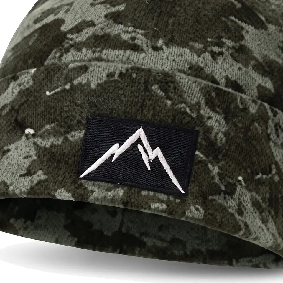Refuge beanie in Sage Camo: close-up of the cuff patch