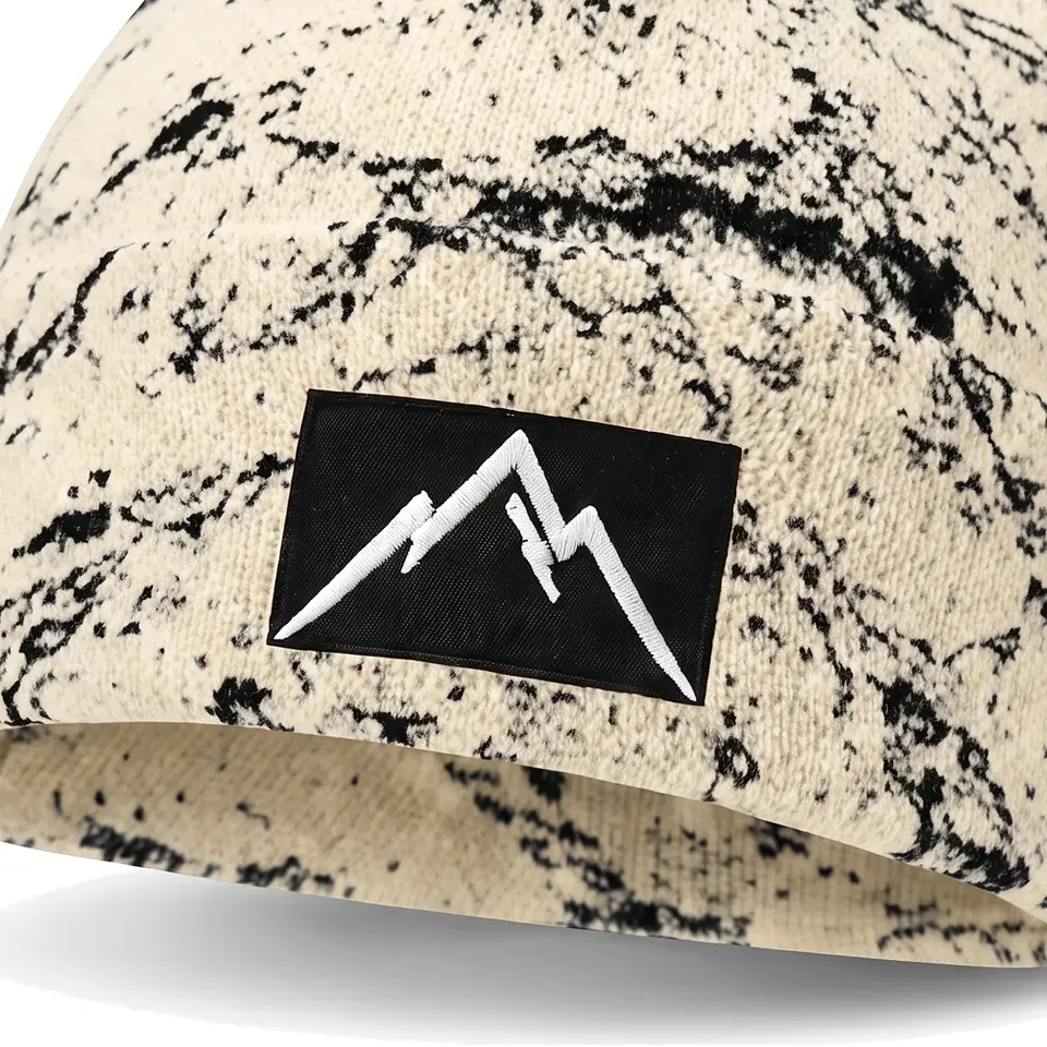 Refuge beanie in Cream Veined Marble: close-up of the cuff patch