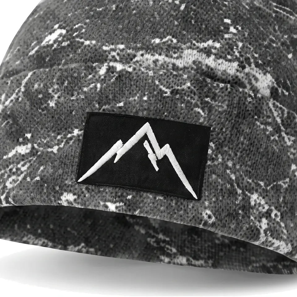 Refuge beanie in Grey Veined Marble: close-up of the cuff patch
