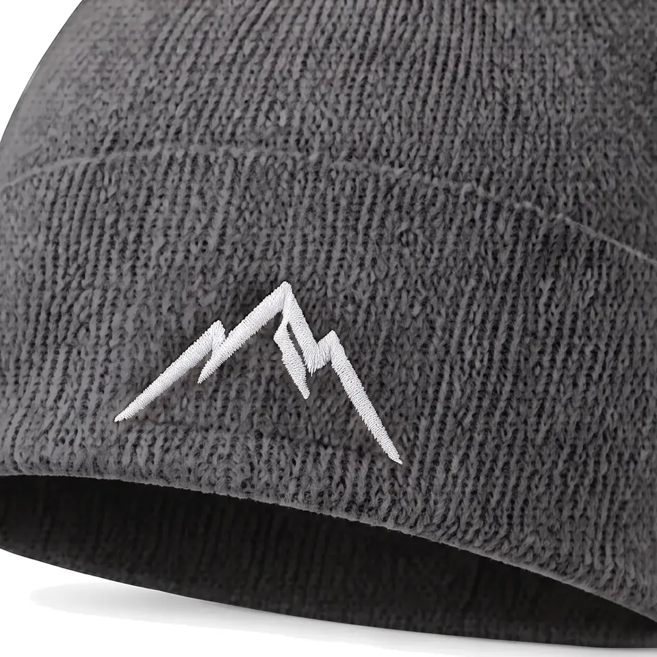 Atelier beanie in Charcoal: close-up of the cuff embroidery