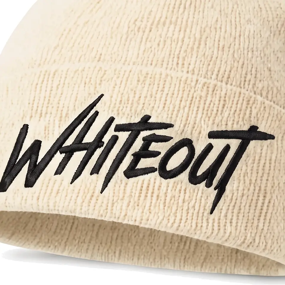 Chalet beanie in Cream: close-up of the cuff embroidery
