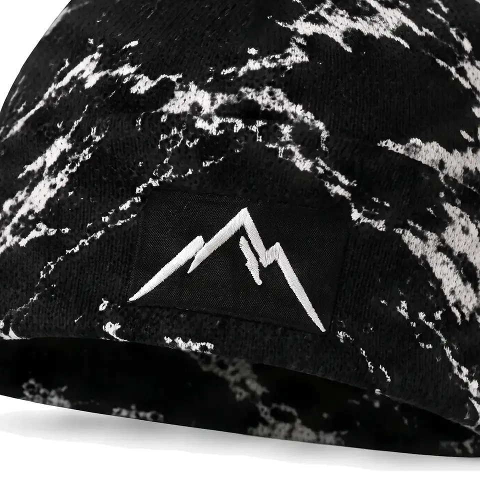 Refuge beanie in Black Bold Marble: close-up of the cuff embroidery