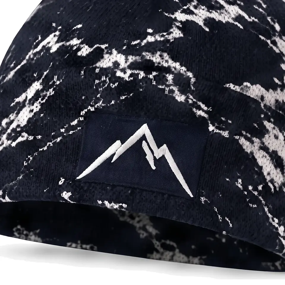 Refuge beanie in Navy Bold Marble: close-up of the cuff embroidery