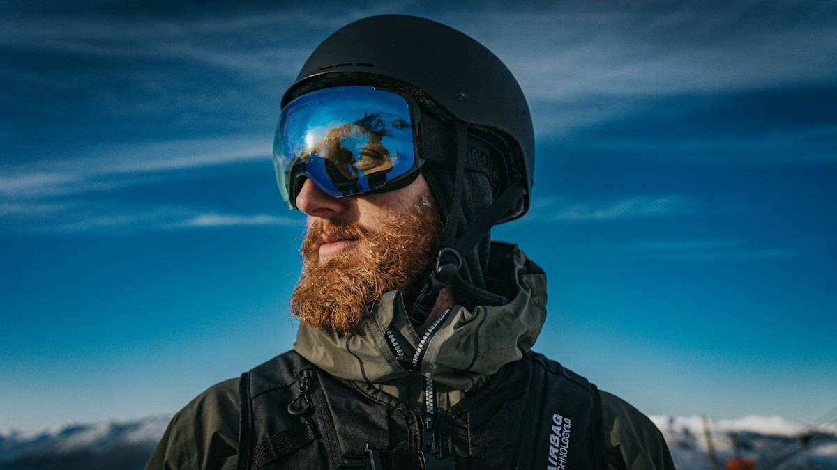 Skier with mirrored goggles looking away