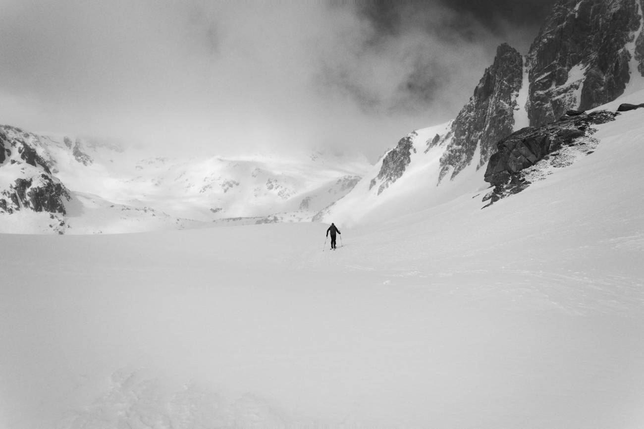 Lone skier traversing a vast snowfield