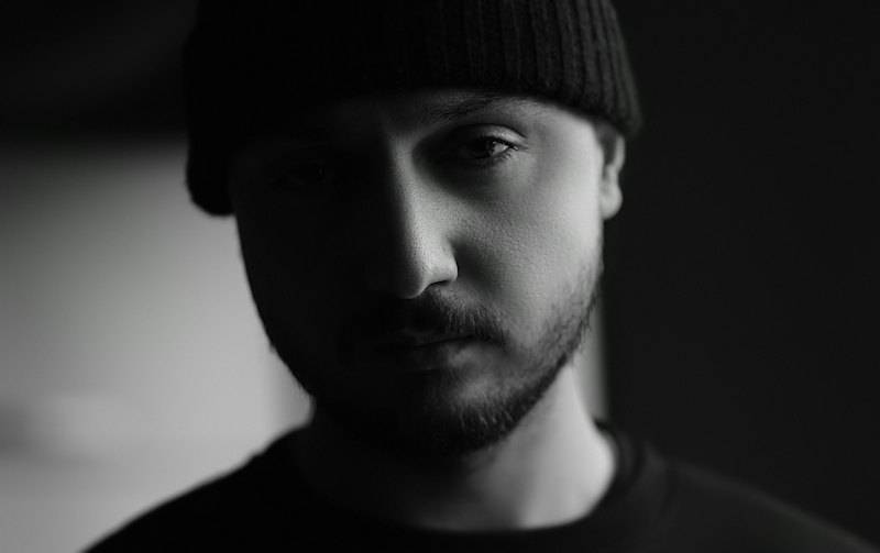 Black and white portrait of a man in a knit beanie