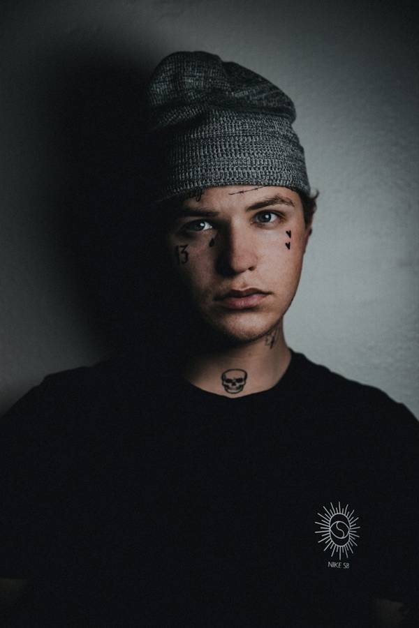 Man in a grey knit beanie, studio-lit portrait
