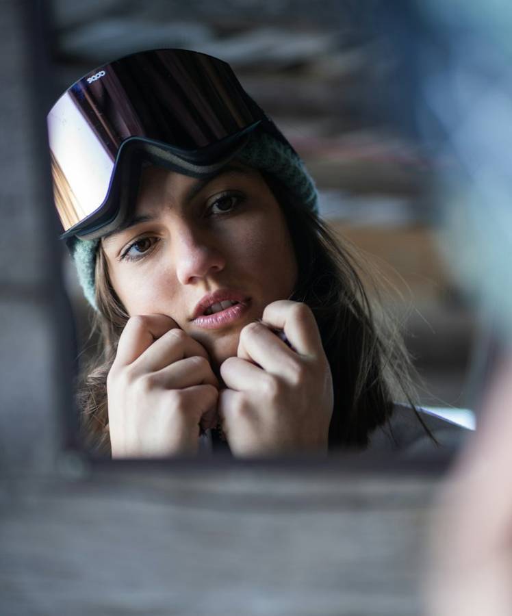 Model adjusting goggles, reflected in a mirror