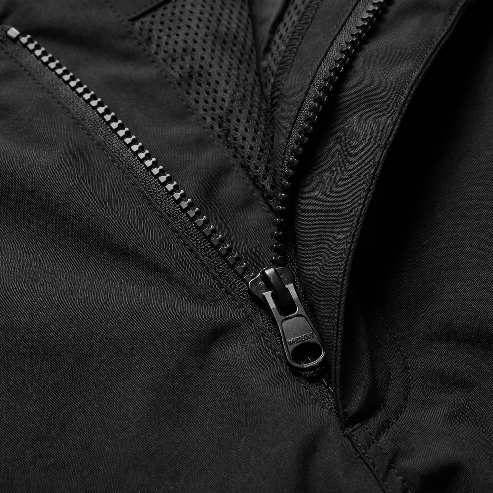 Open ventilation zip revealing mesh lining on black fabric