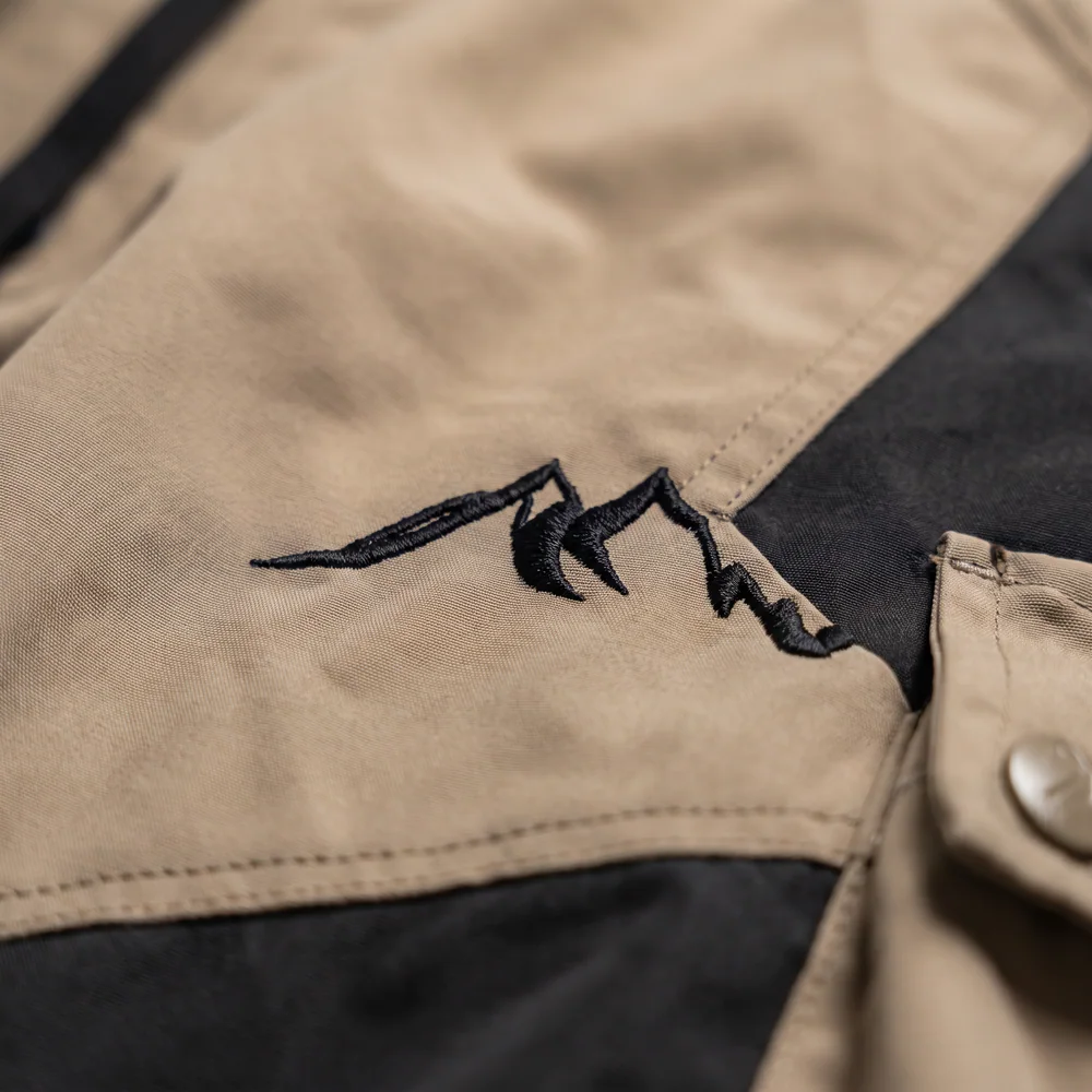 Terrain Tan/Black: logo and embroidery close-up, concept render