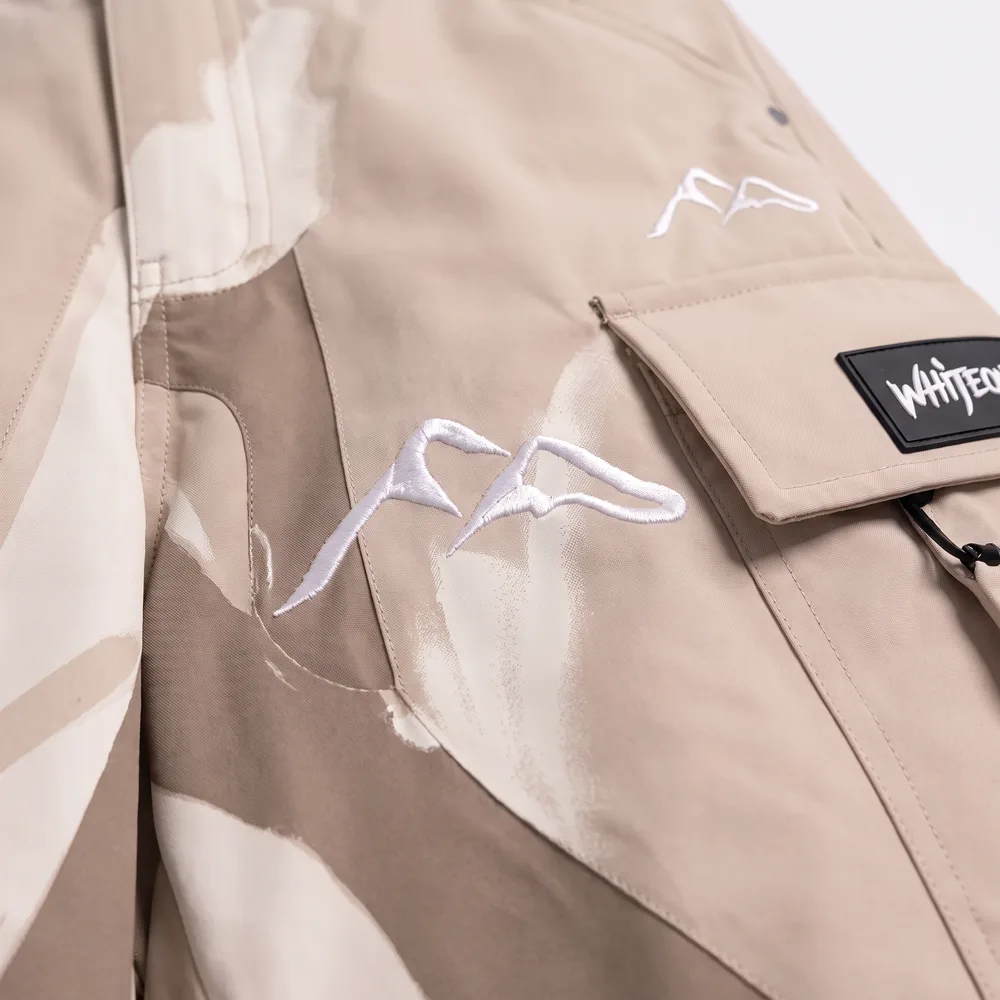 Tundra Dune Sand / Cream: logo and embroidery close-up, concept render