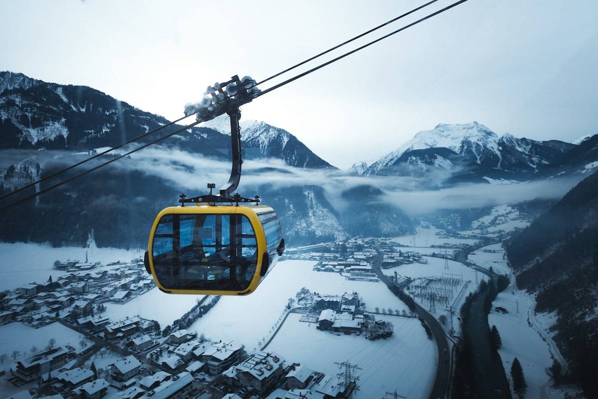 Yellow gondola above a snowy village